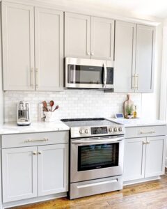 kitchen with white cabinets, steel microwave and stove