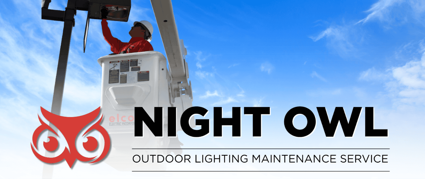 Professional electrician in bucket truck repairing parking lot lighting fixtures with Night Owl logo - South Florida commercial lighting maintenance service