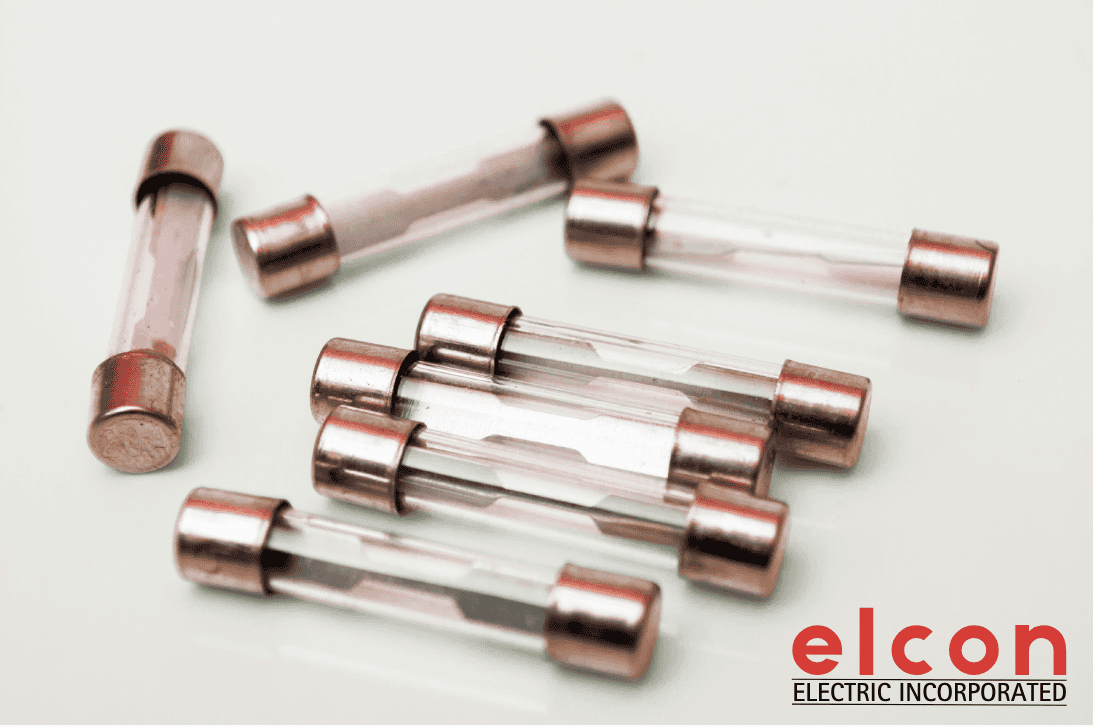 Multiple glass tube electrical fuses with copper end caps arranged on white background - Elcon Electric fuse replacement and repair services