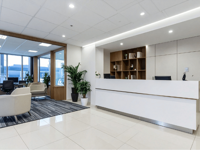 Modern Fort Lauderdale office reception area with recessed LED lighting and linear ceiling illumination