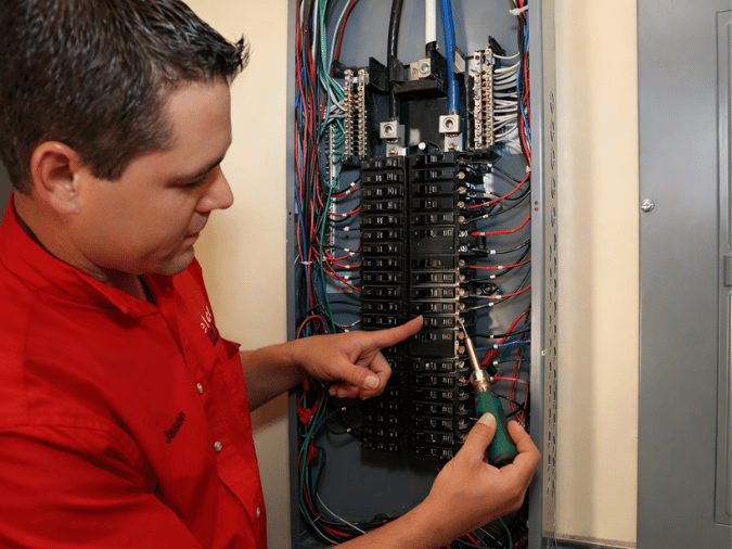 Elcon Electric electrician evaluating an electrical panel before lighting installation and repair in Fort Lauderdale
